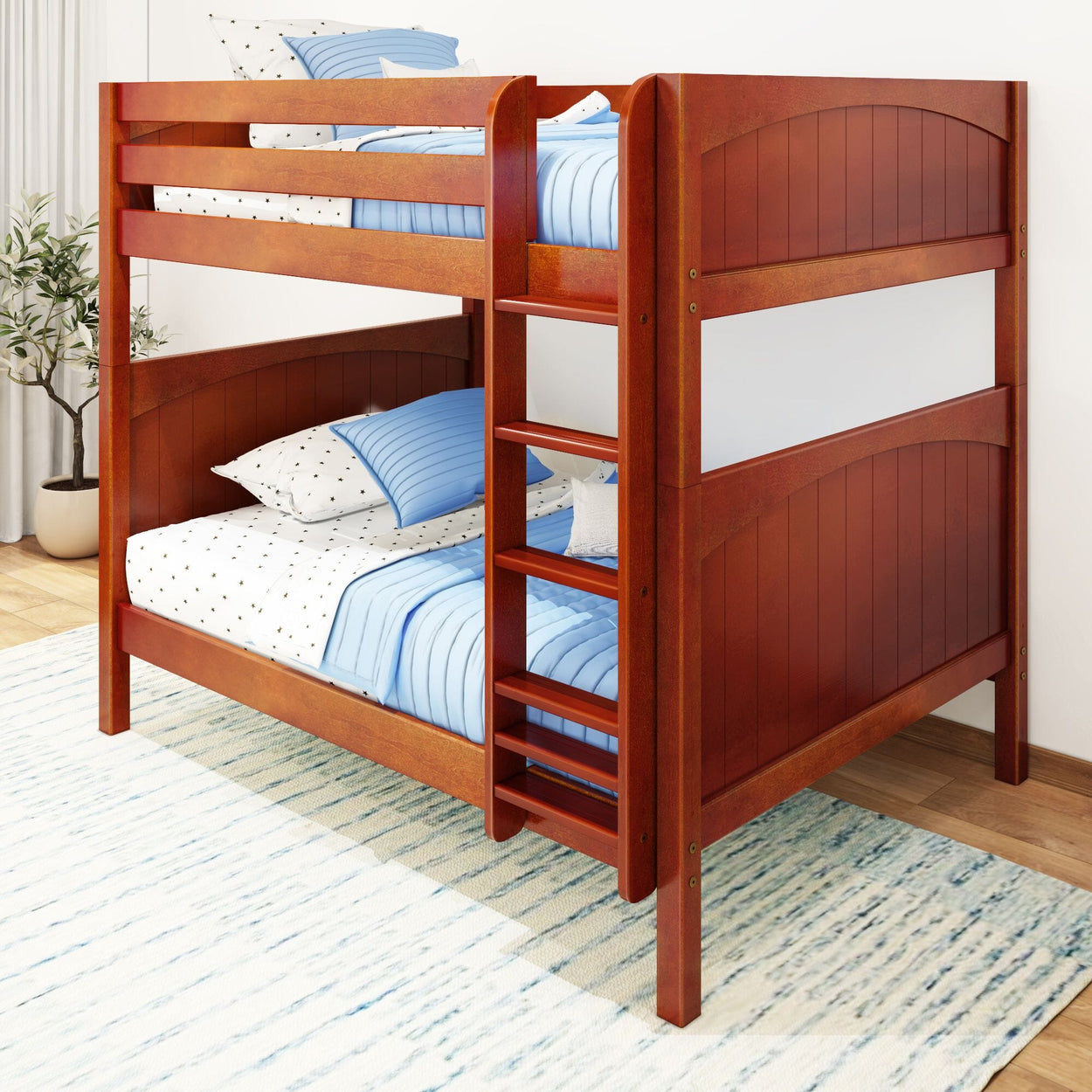 Wooden bunk bed with blue bedding in a bright bedroom setting.