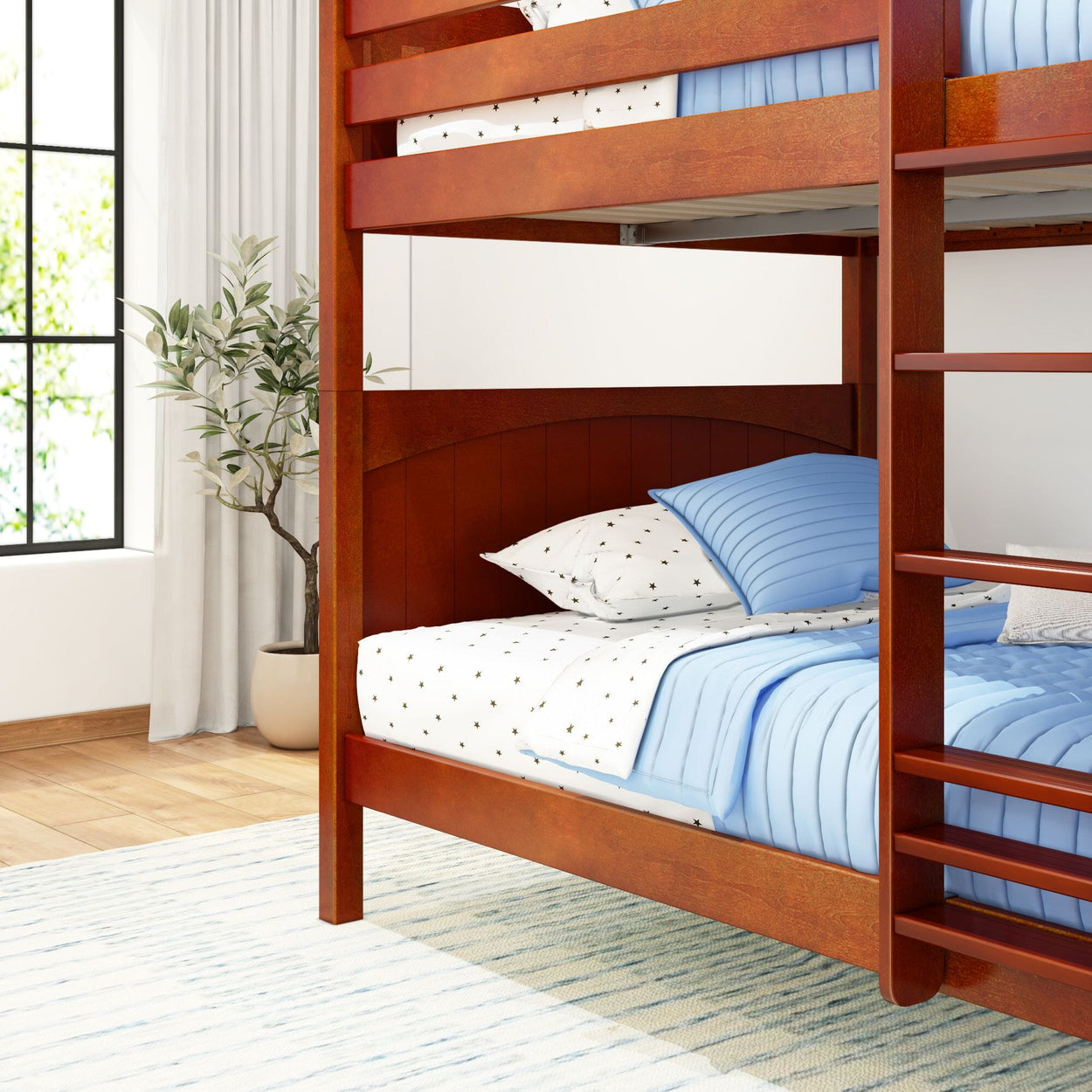 Wooden bunk bed with blue bedding in a bright modern bedroom.