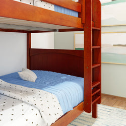Rustic wooden bunk bed with blue bedding in modern bedroom setting.
