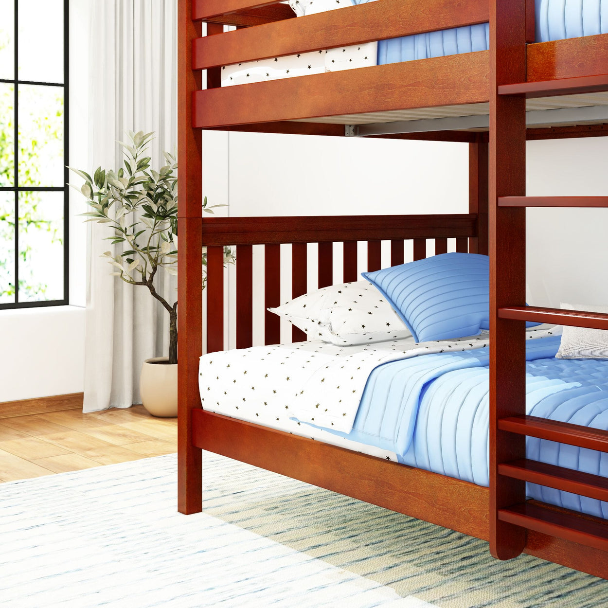 Wooden bunk bed with blue bedding in a bright, airy bedroom with a potted plant and light-filled window.