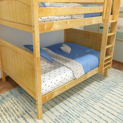 Wooden bunk bed with blue and white bedding in a cozy bedroom setting.