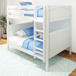 White wooden bunk bed with blue bedding and polka dot sheets in a cozy bedroom setting.