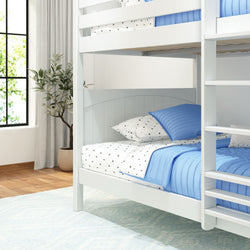 White wooden bunk bed with blue bedding and star-patterned pillows in a bright, cozy bedroom.
