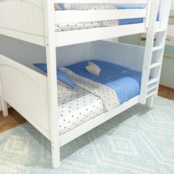 White wooden bunk bed with blue and star-patterned bedding in a children's bedroom.