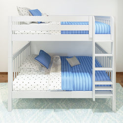 White wooden bunk bed with blue and polka dot bedding, featuring ladder and decorative pillows in a modern bedroom.