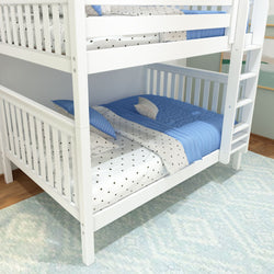 White wooden bunk bed with blue bedding and star-patterned sheets in a cozy children's room.