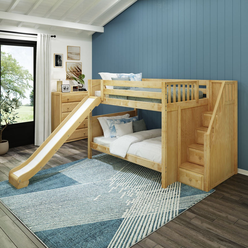 Modern kids bedroom with natural wood bunk bed and slide, built-in storage stairs, blue accent wall, dresser, and patterned area rug