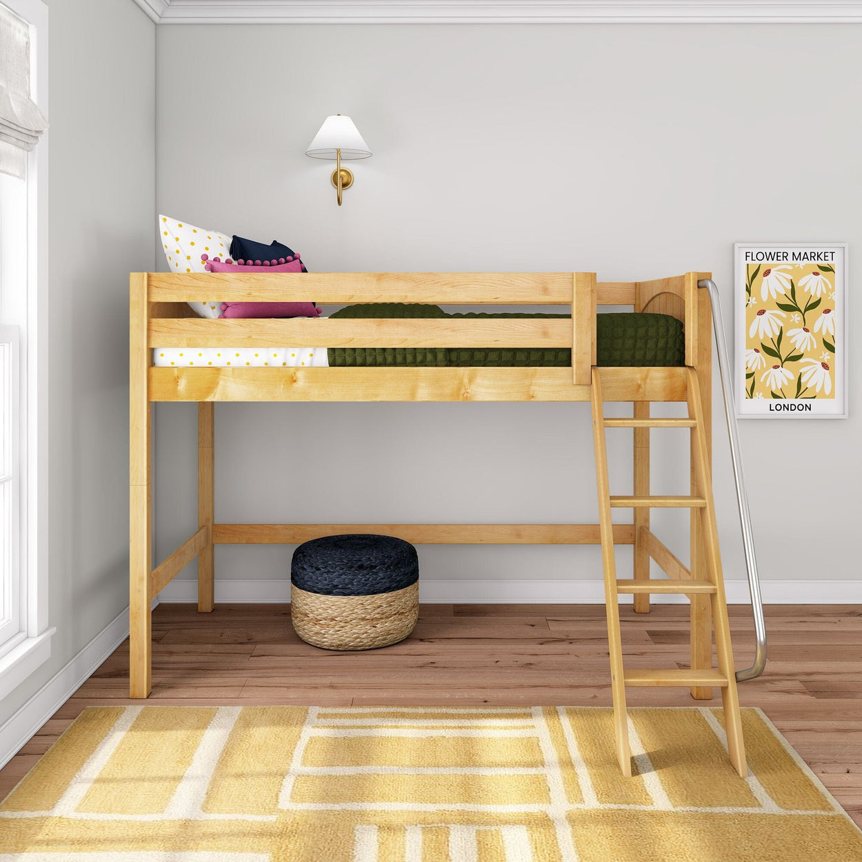 Natural wood loft bed with ladder in a modern kids' bedroom, green quilted bedding and colorful pillows, wall sconce and "Flower Market" print, woven pouf and yellow geometric rug on hardwood floor