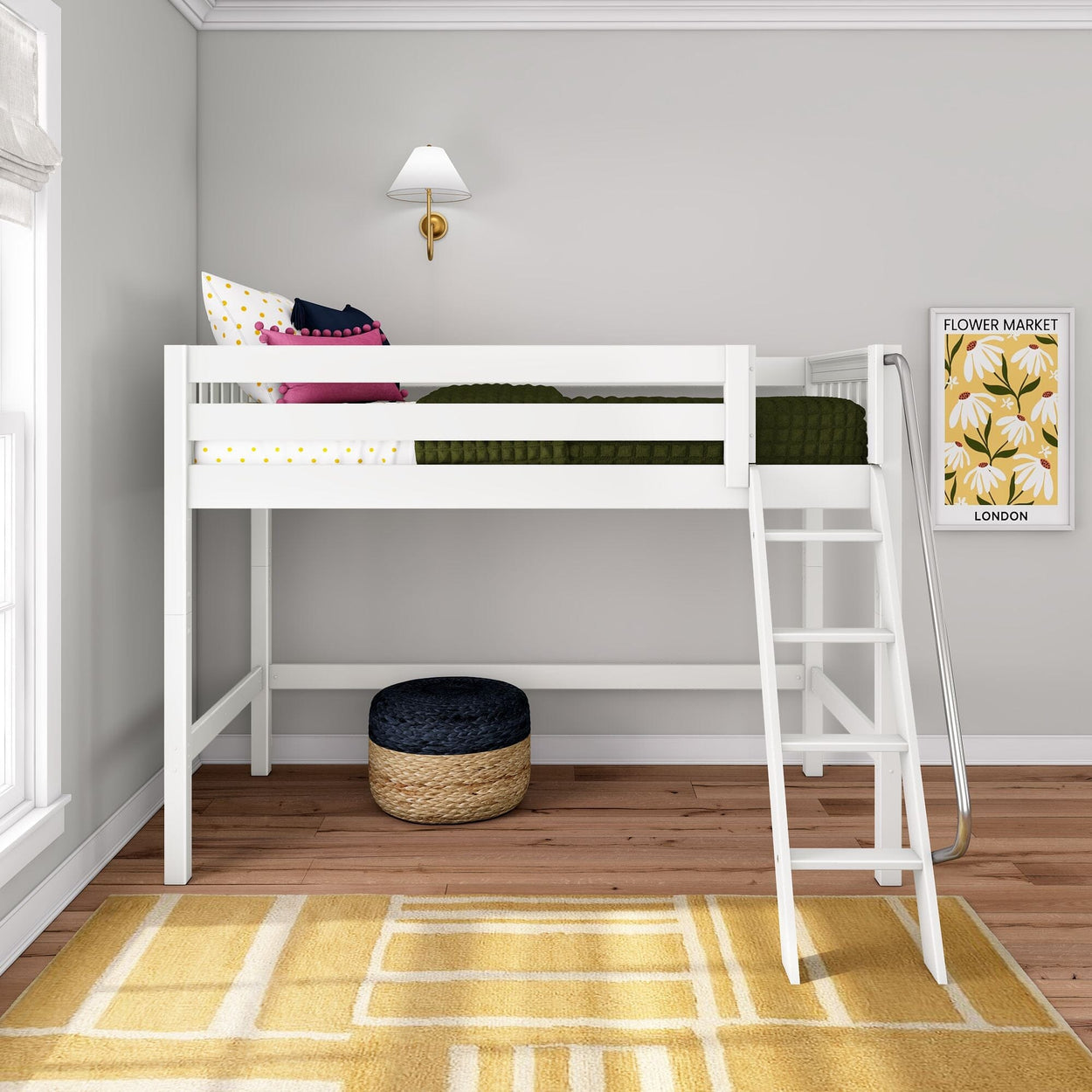 White wooden loft bed with ladder in modern children's bedroom, green bedding and polka-dot pillows, brass wall sconce, Flower Market framed print, woven pouf and yellow geometric rug on hardwood floor.