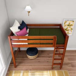 Wooden loft bed with ladder in modern children's bedroom, green quilted bedding, polka-dot and pom-pom throw pillows, wall sconce, floral poster and woven pouf