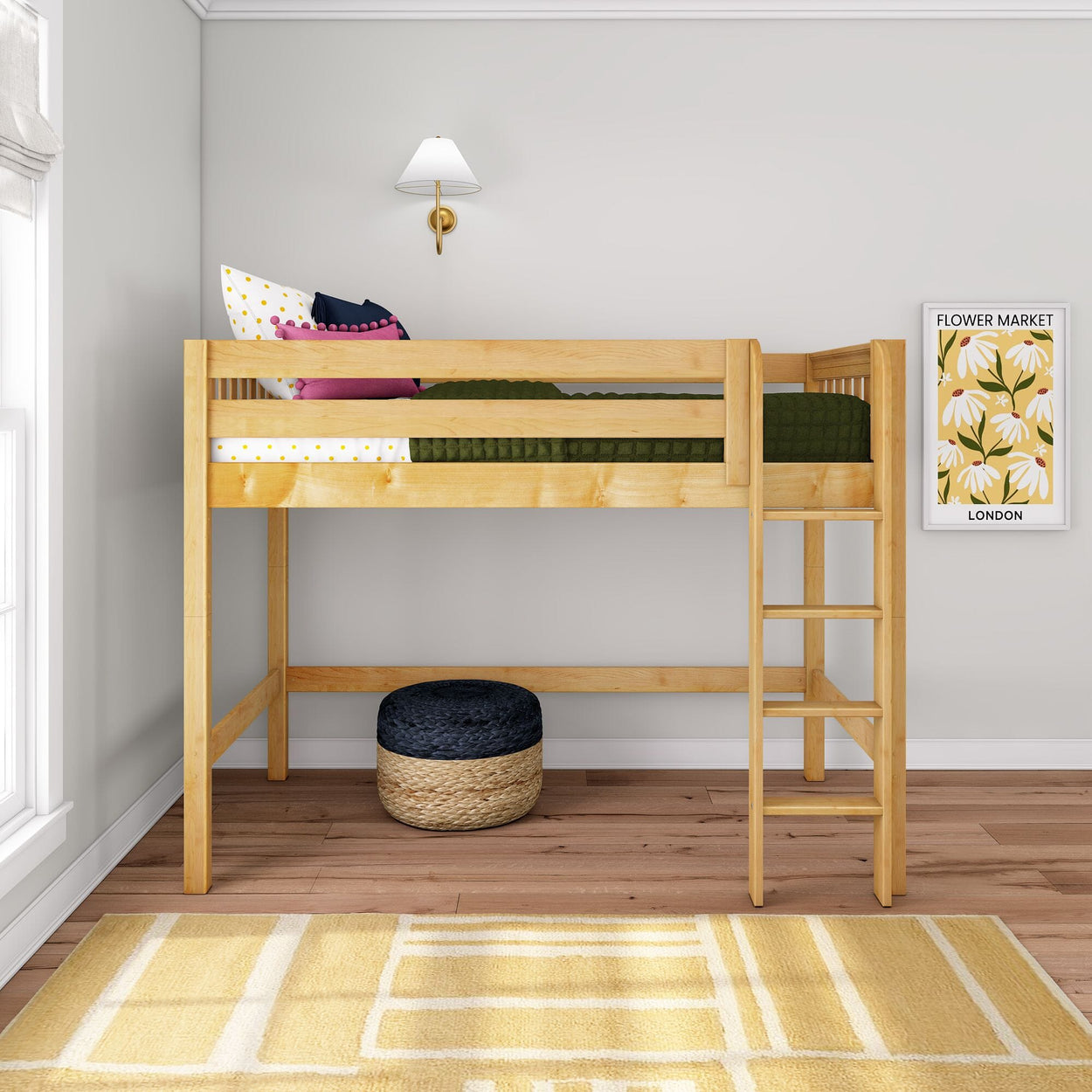 Natural pine twin loft bed with ladder in kids' bedroom, green bedding and colorful pillows, wall sconce and framed flower market poster, woven pouf underneath on hardwood floor with yellow geometric rug — space-saving bunk/loft bed for small rooms