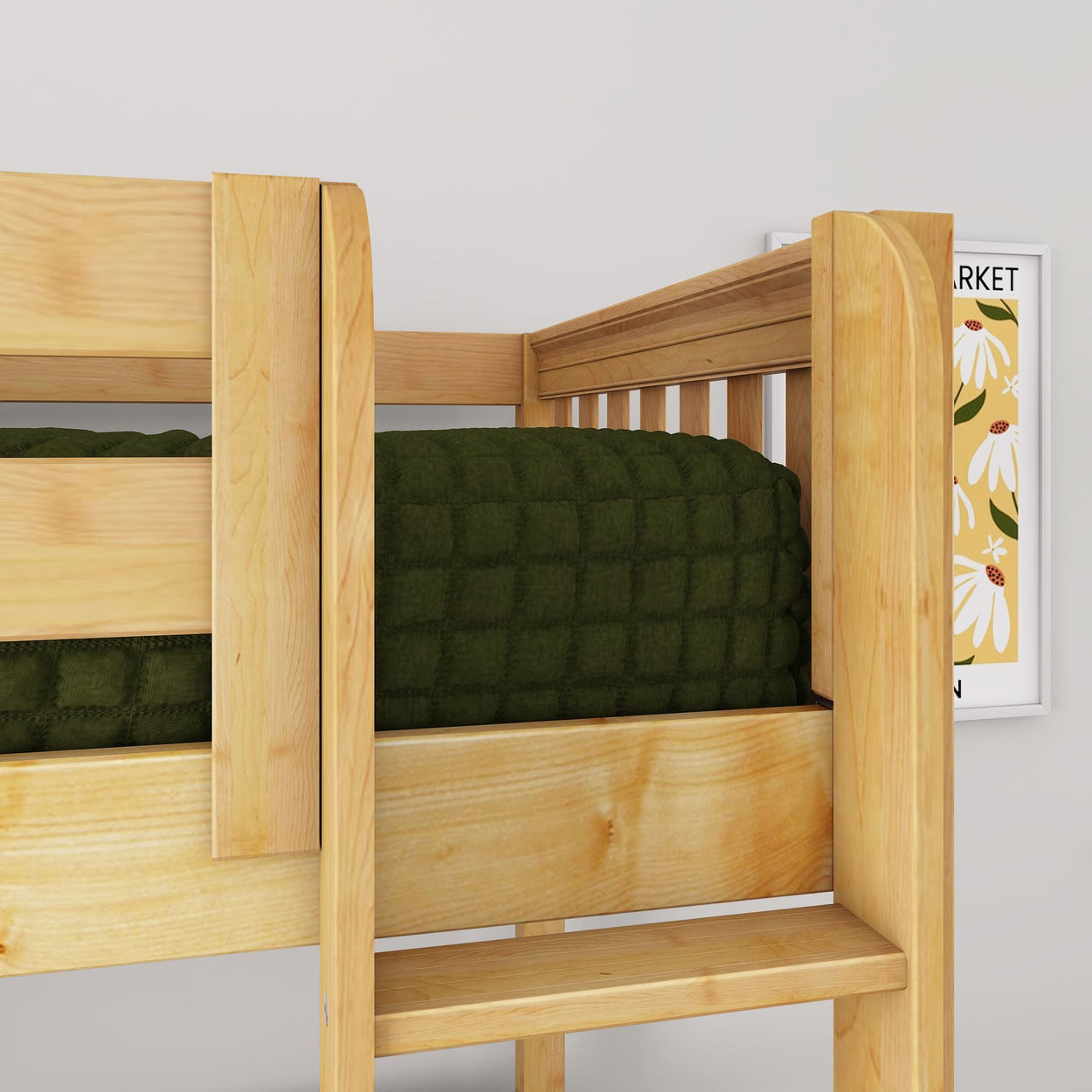 Close-up of a natural wood bunk bed ladder and guardrail with dark green quilted bedding and framed floral wall art in a modern kids' bedroom