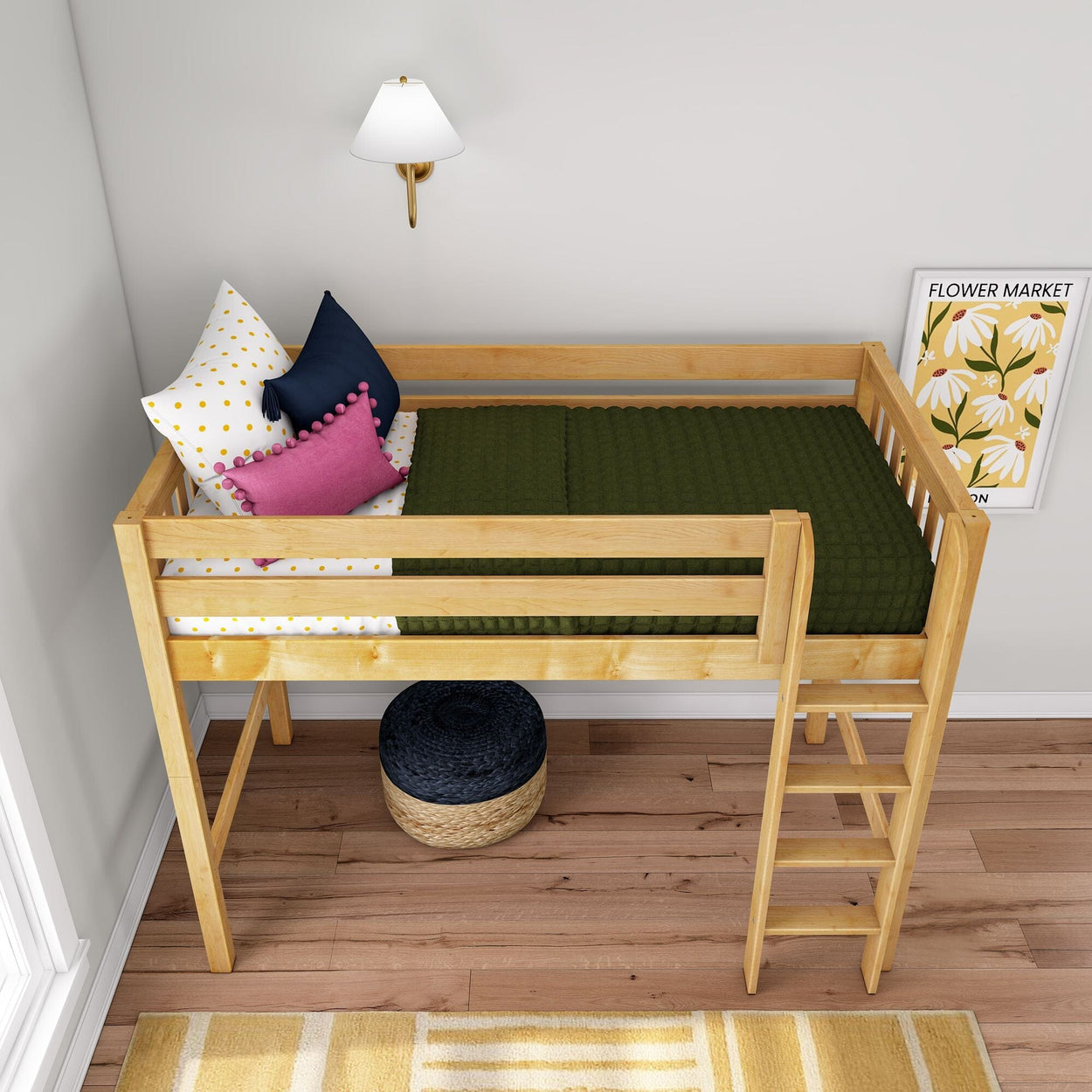 Natural wood loft twin bed with ladder in children's room, green quilted blanket, polka-dot and pink accent pillows, wall sconce and floral "Flower Market" print, hardwood floor and woven ottoman, modern kids bedroom decor
