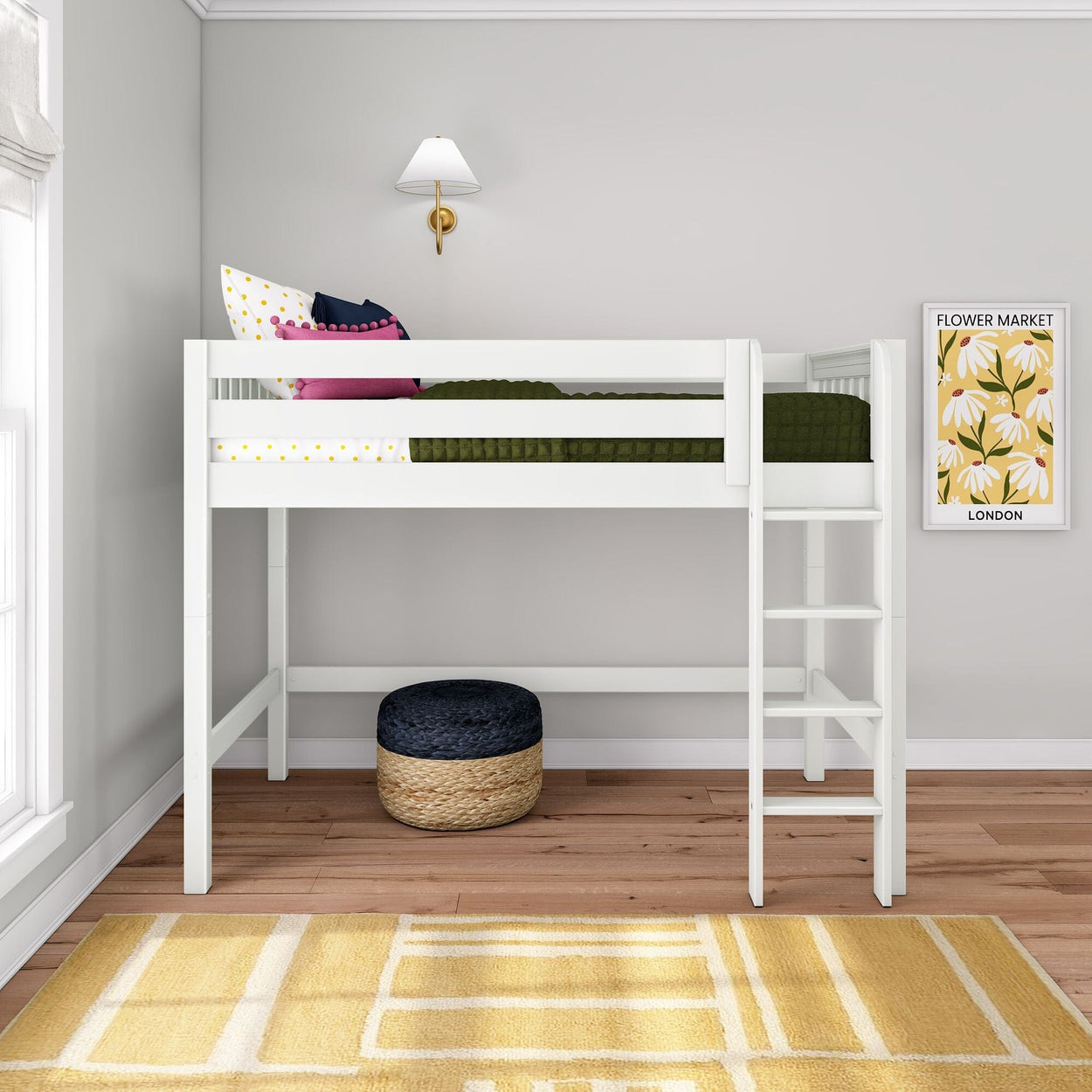 White loft bed with ladder in modern kids bedroom, green quilt, pink pillows, wall sconce, Flower Market print, woven ottoman, yellow rug