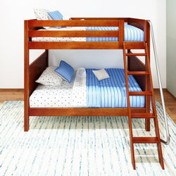 Wooden bunk bed with blue bedding and polka dot pillows in a modern bedroom.