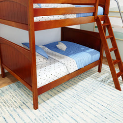 Wooden bunk bed with blue and white bedding in a modern bedroom.