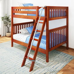 Wooden bunk bed with ladder in a bright room featuring blue bedding and an area rug.