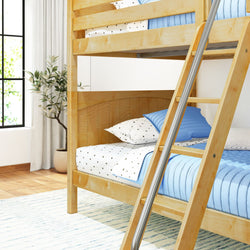 Wooden bunk bed with blue and white bedding in a bright bedroom with a plant and large window.