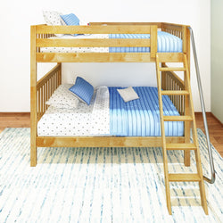 Wooden bunk bed with blue bedding and polka dot sheets in bright children's bedroom.