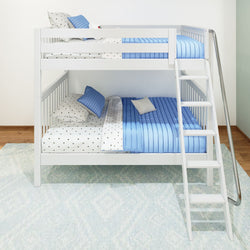White bunk bed with blue and star-patterned bedding, featuring a ladder, situated on a light patterned rug in a bright room.