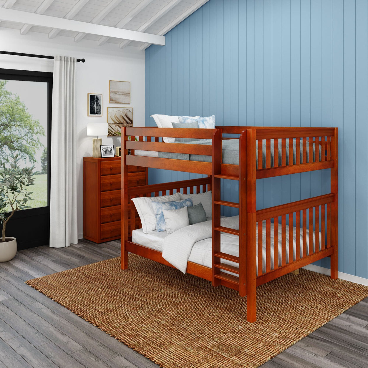 Wooden bunk bed in a bright bedroom with blue wall décor and natural light.