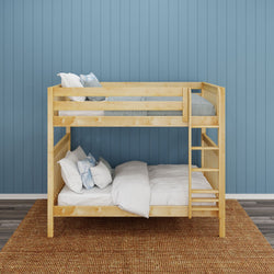 Wooden bunk bed with white bedding and blue pillows, positioned against a blue paneled wall over a woven rug.