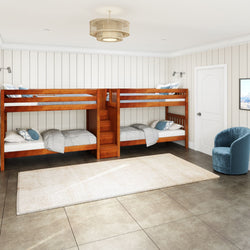 Modern bedroom with wooden bunk beds, cozy seating area, and elegant decor.