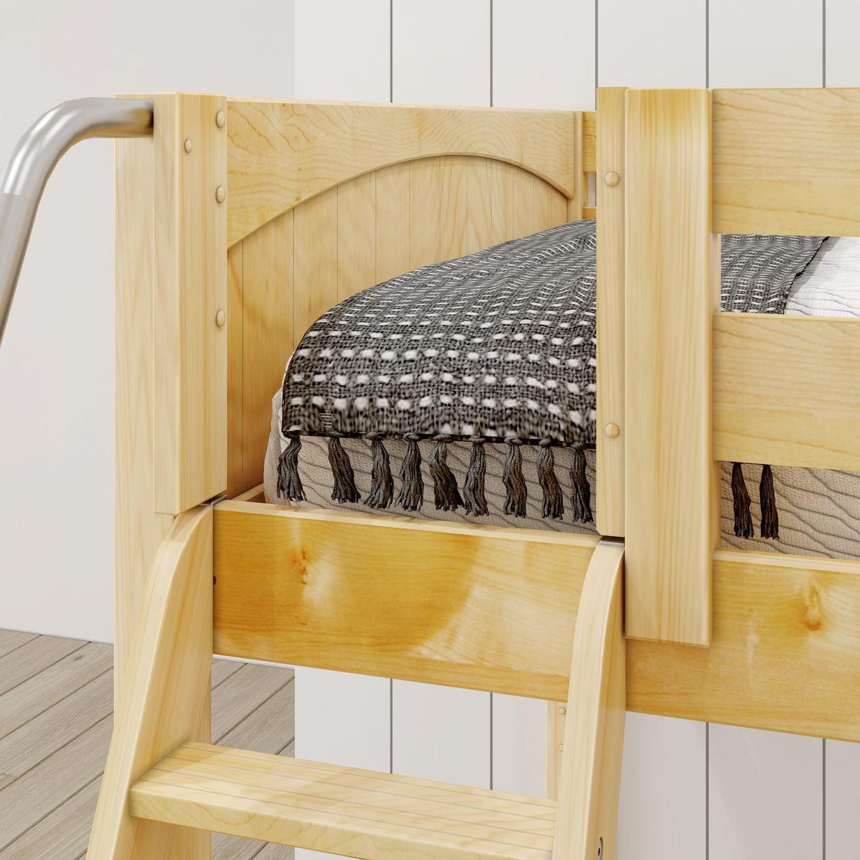 Elevated wooden bunk bed with cozy black and white blanket, ideal for small bedrooms.