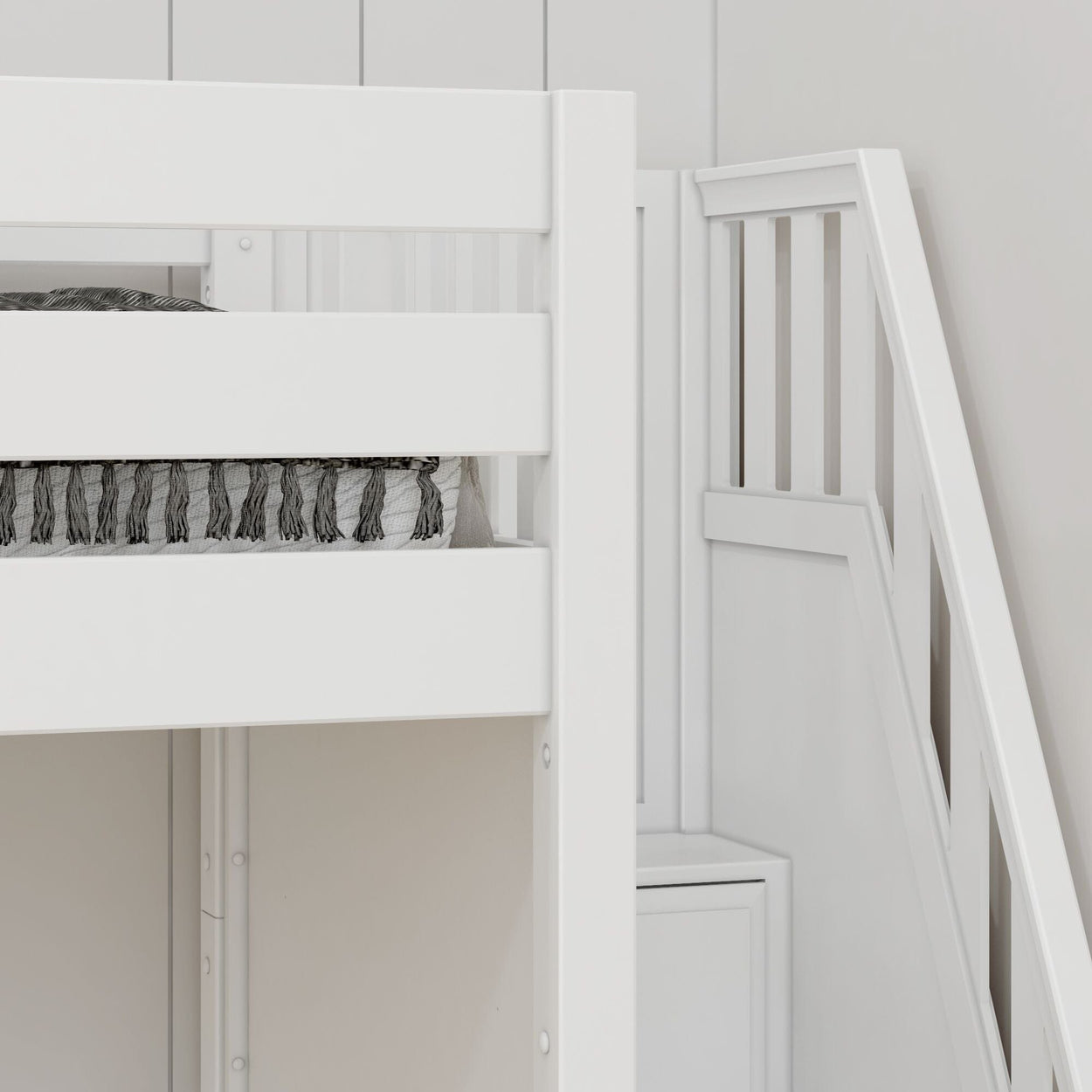 White wooden bunk bed with storage stairs and decorative bedding in a modern bedroom.