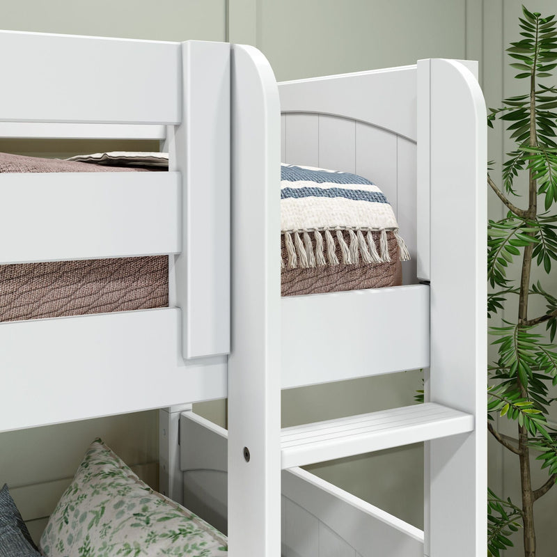White wooden bunk bed ladder and guardrail close-up with blue-striped quilt, woven tassel throw and potted plant