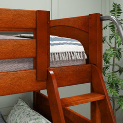 Wooden bunk bed with ladder, decorative blue and white throw blanket, and potted plant.