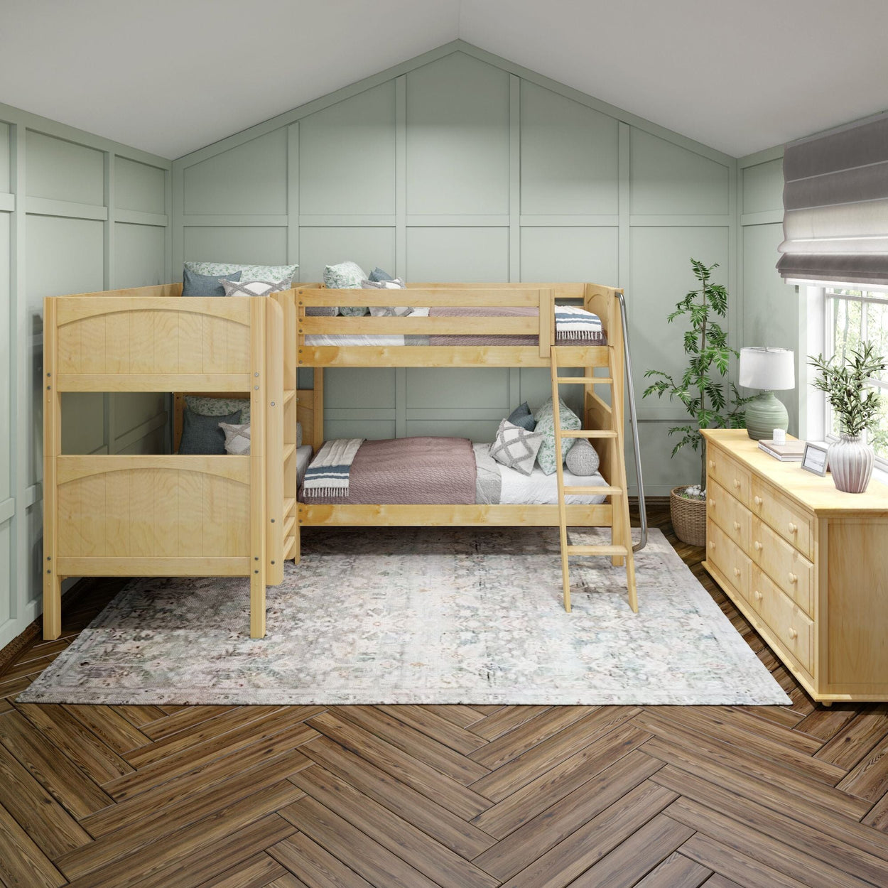 Wooden bunk bed in a stylish bedroom with green walls, hardwood floor, and a cozy dresser.