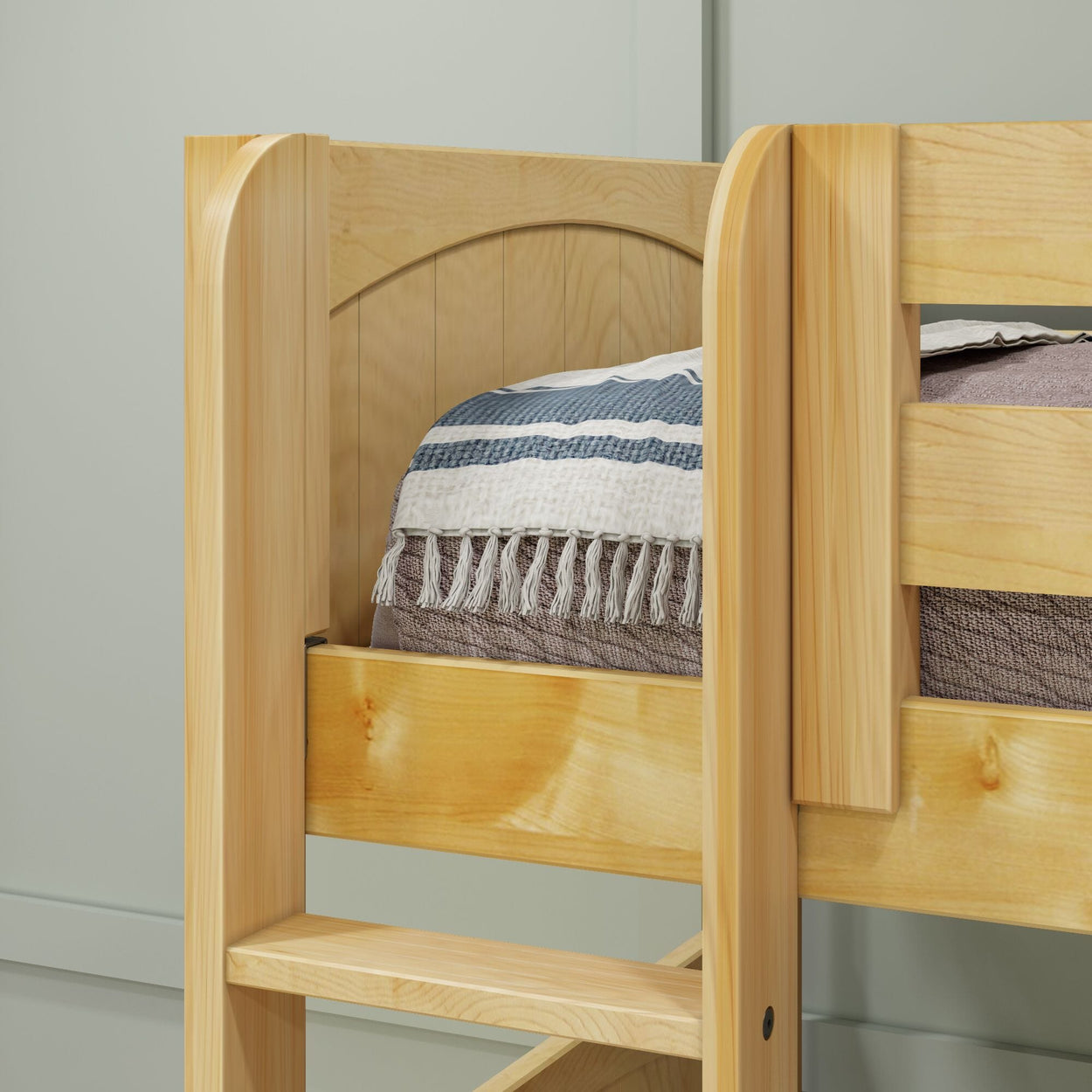 Wooden bunk bed with ladder and cozy striped blanket.