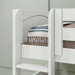 White wooden bunk bed frame with cozy blankets in a minimalist bedroom setup.