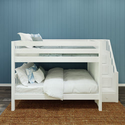 White bunk bed with stairs against a blue wall in a modern bedroom setting.