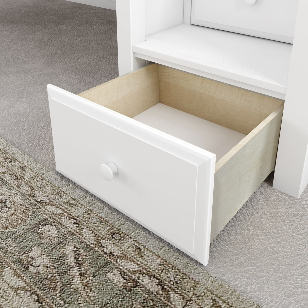 Open white wooden drawer in modern home interior setting on carpet floor.
