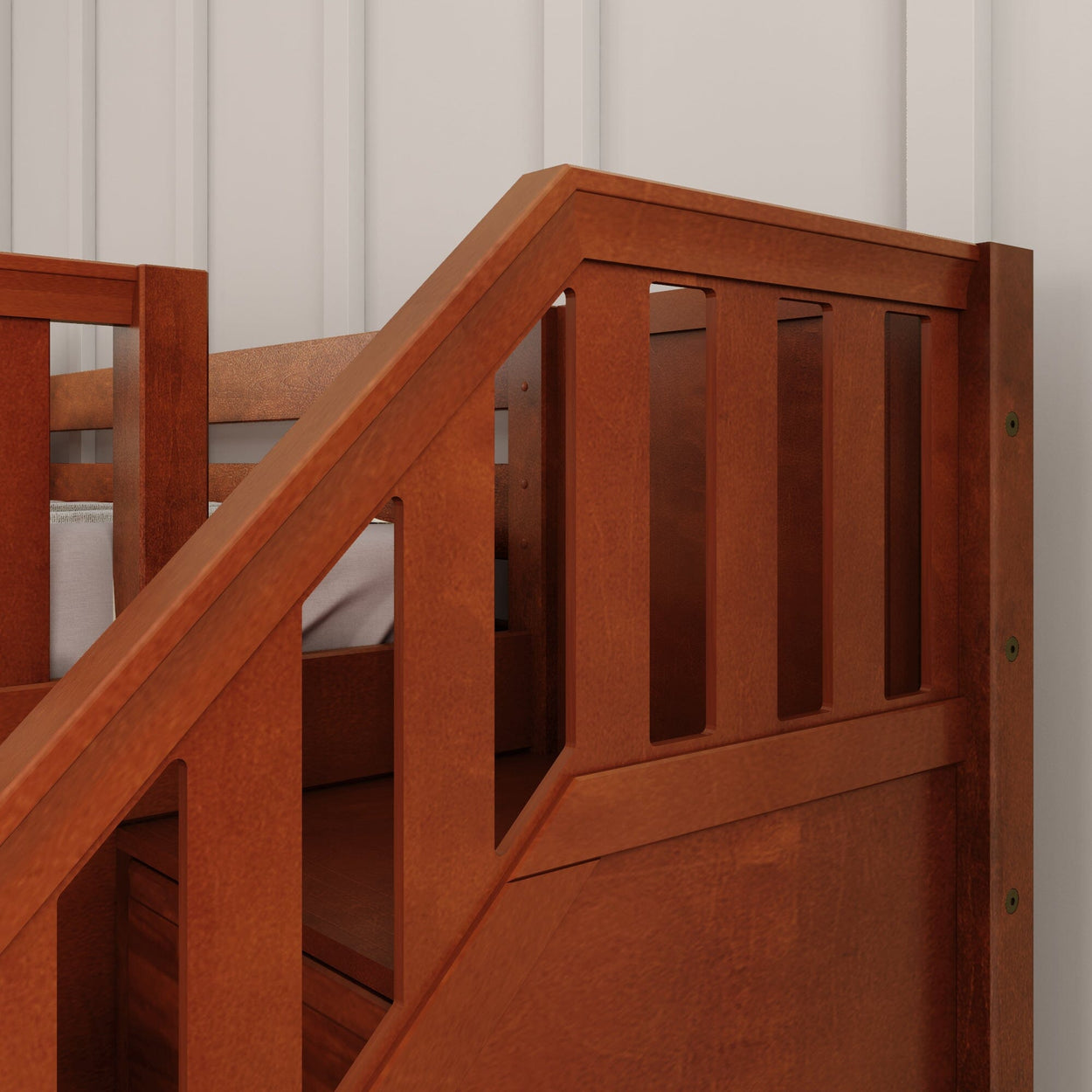 Wooden bunk bed with sturdy side rails and a warm brown finish against a white paneled wall.
