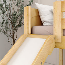 Wooden loft bed with slide and pillow in a modern bedroom with decorative plant.