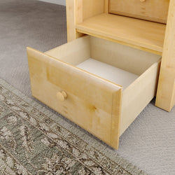 Open wooden chest drawer on carpeted floor displaying interior.