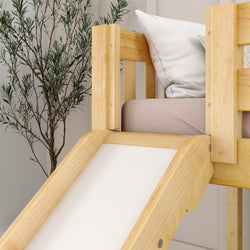 Wooden bunk bed with slide and white pillows, next to a potted plant.