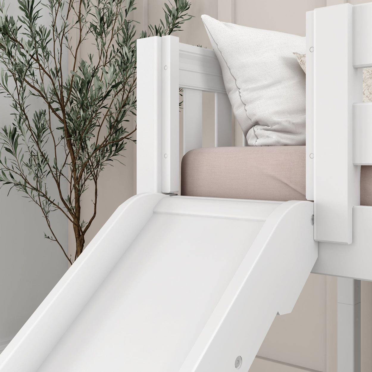 White children's bunk bed with built-in slide, cozy pillows, and indoor plant for modern bedroom decor.