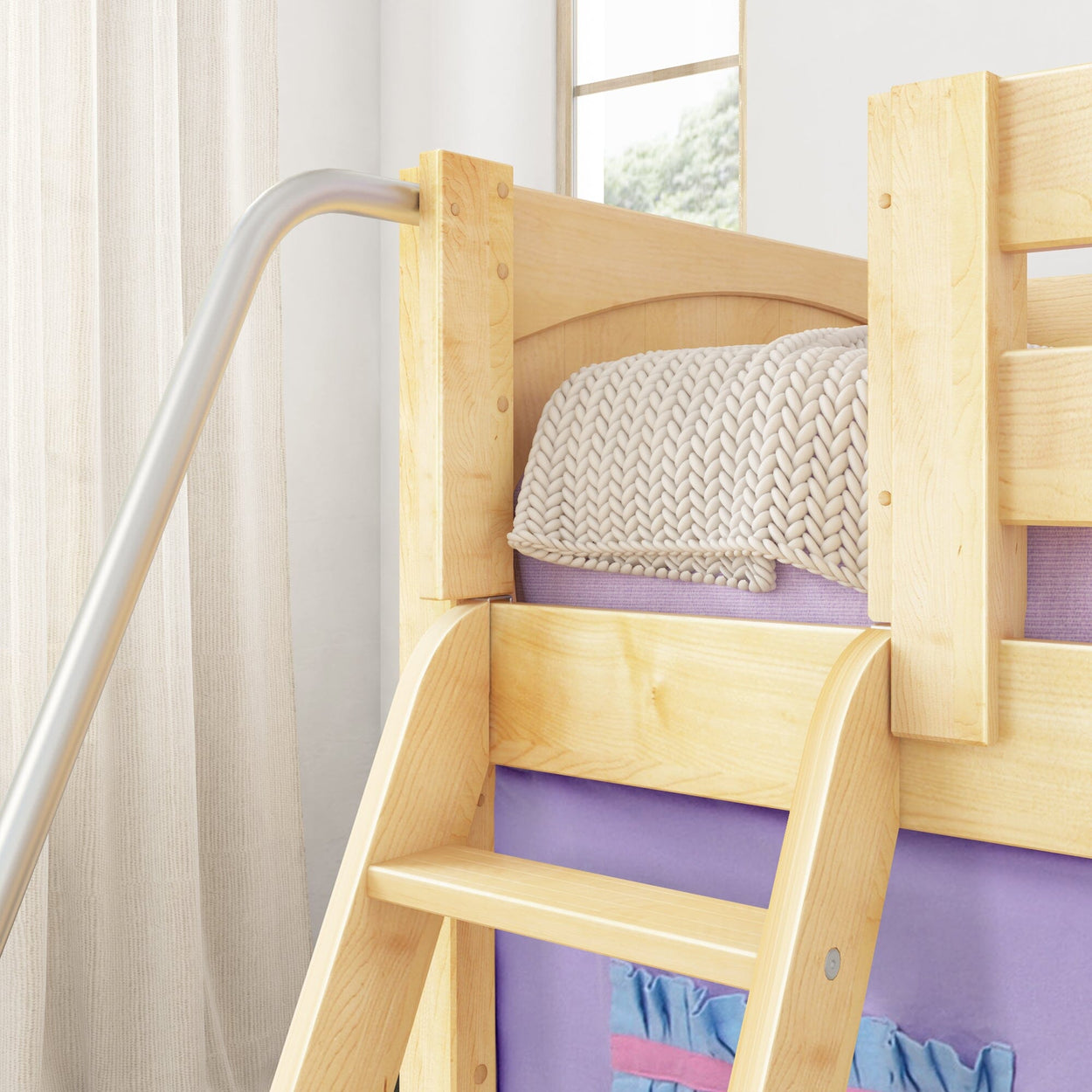 Wooden bunk bed with cozy knitted blanket in a bright bedroom with natural light.