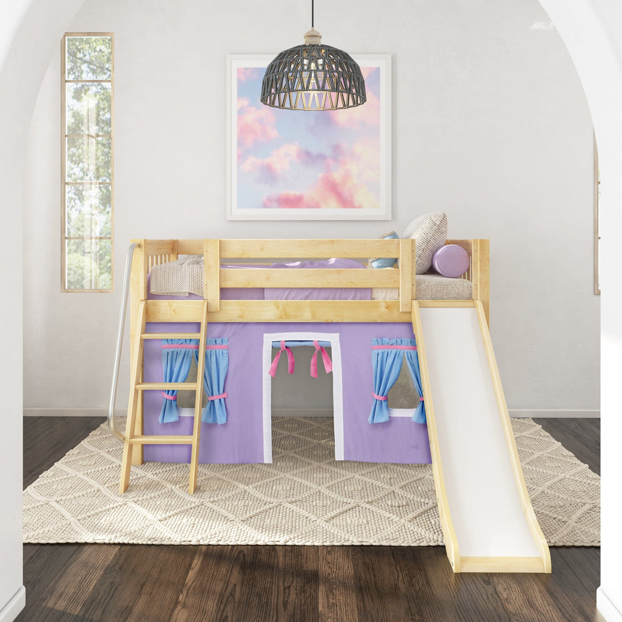 Wooden loft bed with purple playhouse curtains and slide in a modern kids' bedroom.