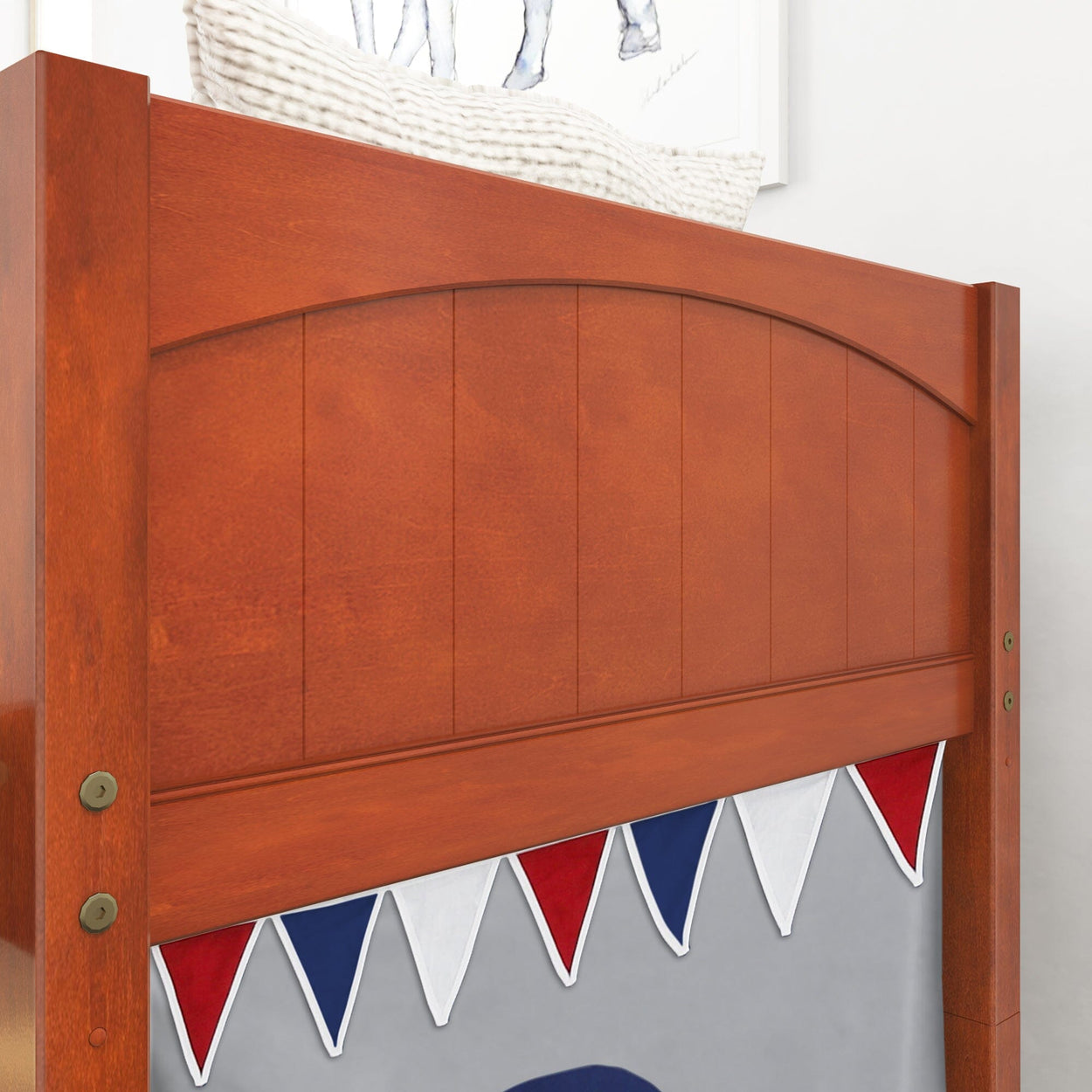 Wooden bunk bed with decorative red, white, and blue bunting detail in a child's bedroom.