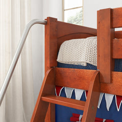 Wooden bunk bed with metal slide and cozy blanket in a bright, modern bedroom.