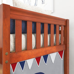 Wooden bunk bed close-up with colorful bunting decor in a child's bedroom.