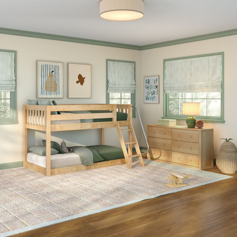 Children's bedroom with natural wood bunk bed and ladder, green bedding, light wood dresser with lamp and toys, striped roman shades and framed alphabet and animal art