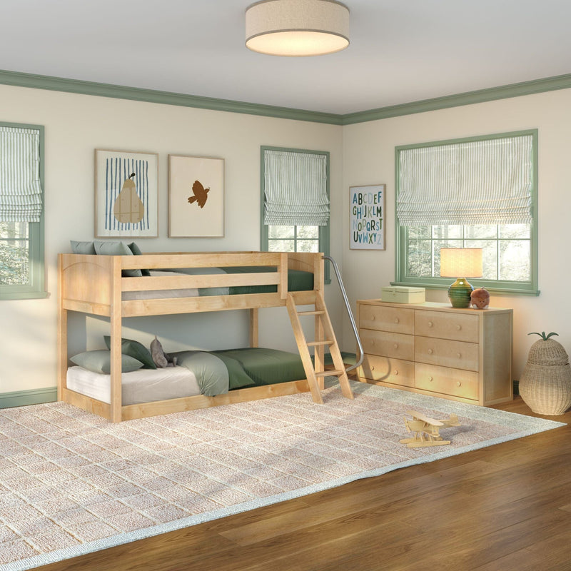 Kids bedroom with natural wood bunk bed, green-trim windows with striped Roman shades, wooden dresser and lamp, framed alphabet and animal prints, and a toy airplane — cozy children's room decor with abundant natural light