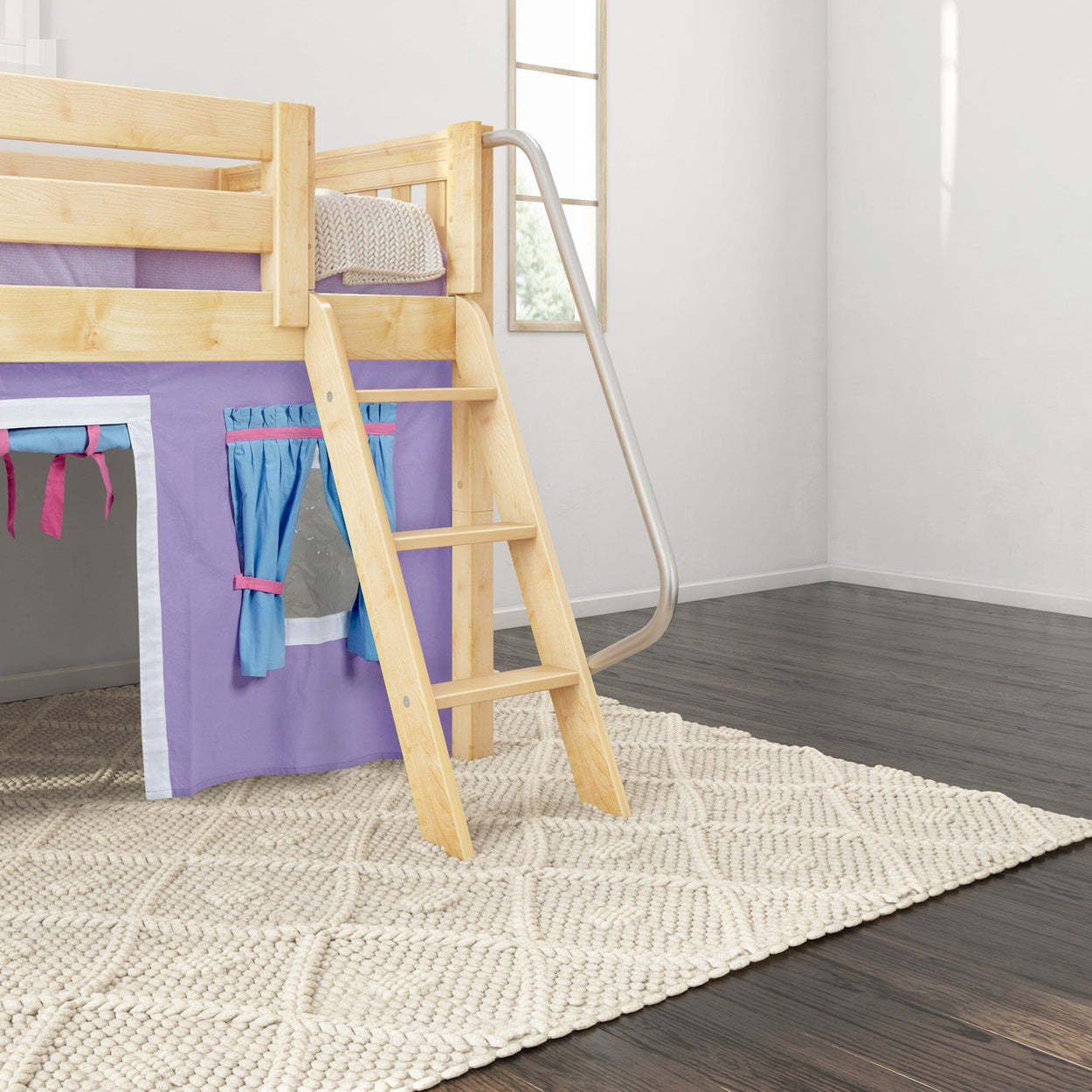 Children's wooden loft bed with ladder and purple curtain, on a light woven rug in a modern kids' bedroom.