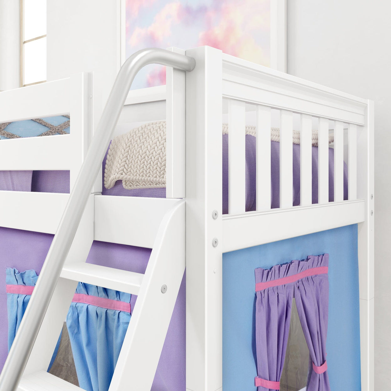White wooden loft bunk bed with colorful curtains and cozy bedding in a bright children's bedroom.